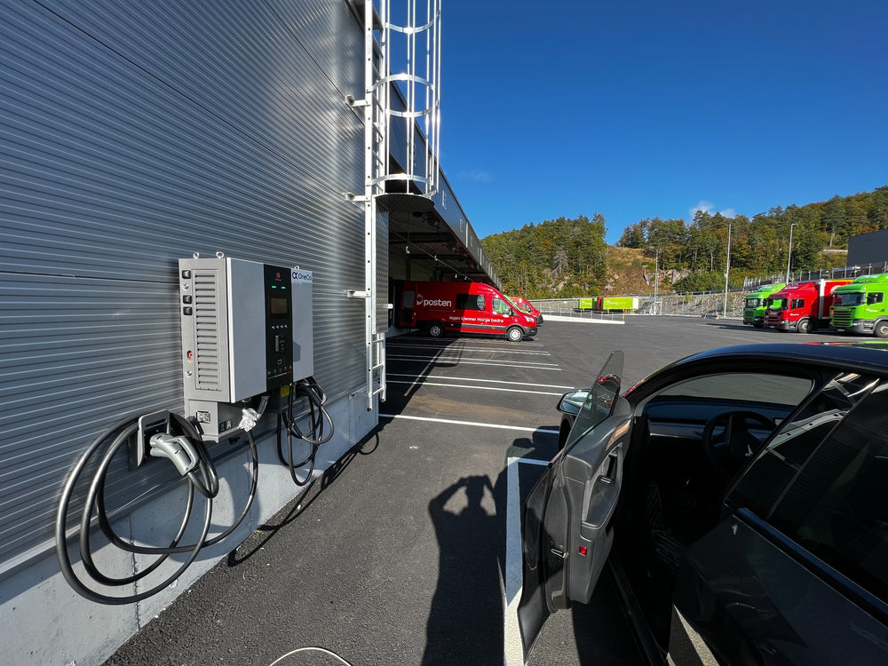 Charging equipment installed alongside a commercial building and parking area.