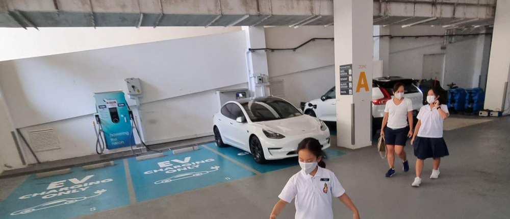 Marked EV charging spaces within a covered parking area.