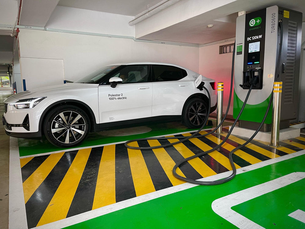 A passenger vehicle at a clearly marked indoor charging bay.