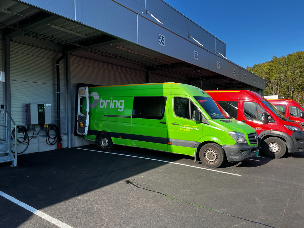 Charging equipment and commercial vans at a loading-bay location.