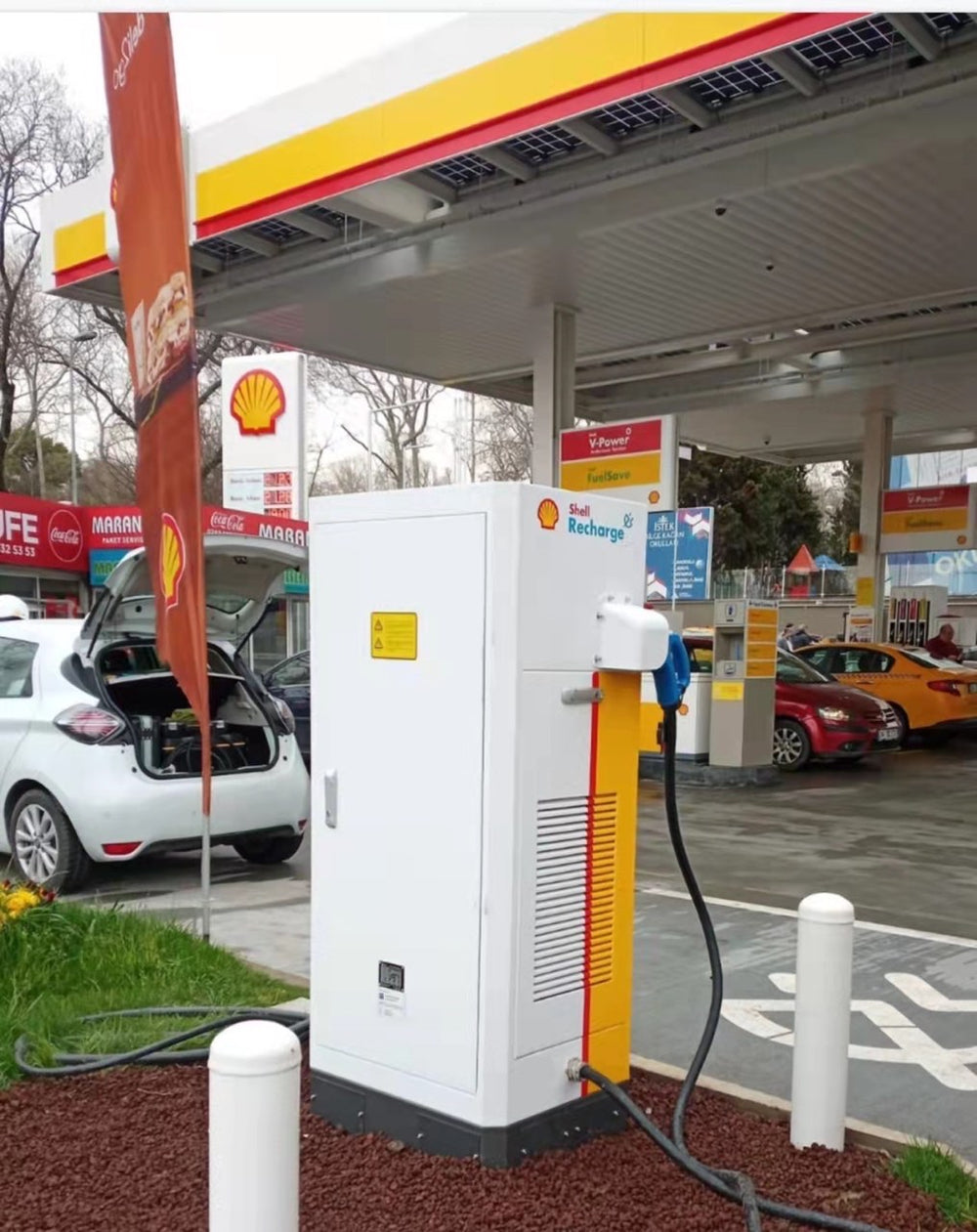 A close view of installed charging equipment at a forecourt.