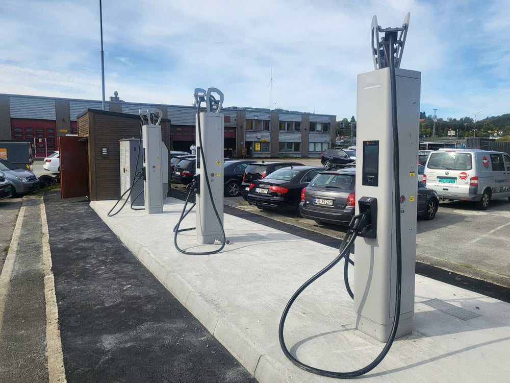 Multiple charging units serving an outdoor passenger-vehicle parking area.