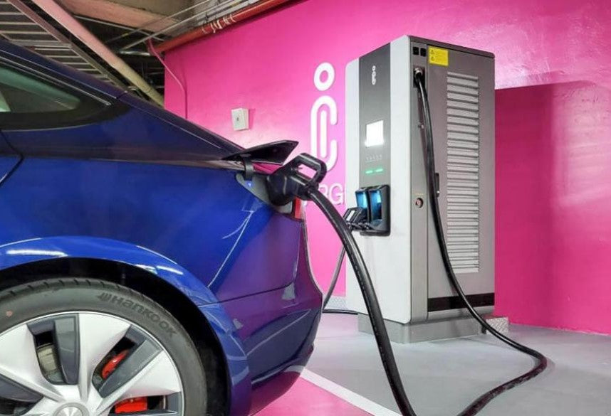 A passenger vehicle connected to the charger at the showcase.