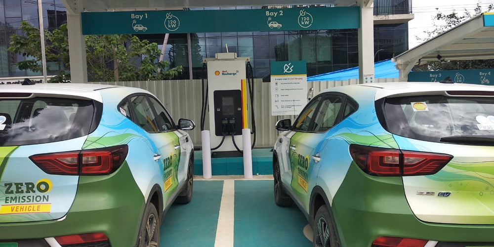 Passenger vehicles parked beside an installed public charging point.