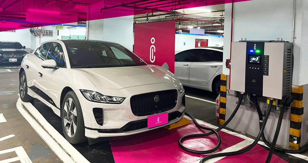 A passenger EV and charging equipment presented in an indoor display area.