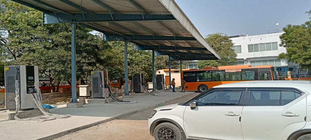 EV chargers beneath a canopy at a charging site in Uttar Pradesh, India